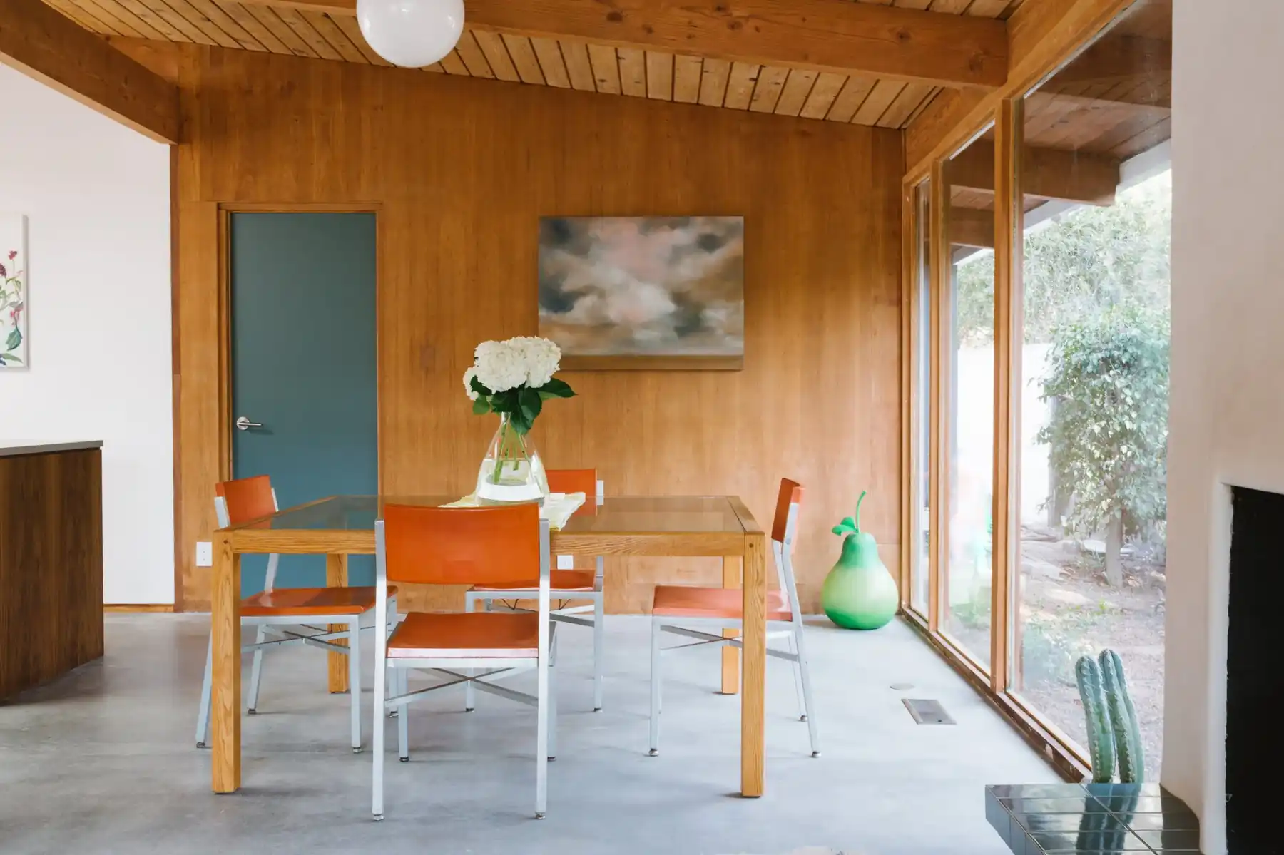 Dining room with wood ceilings and orange leather chairs in a renovated Bill Mack home, Bel Air, Los Angeles