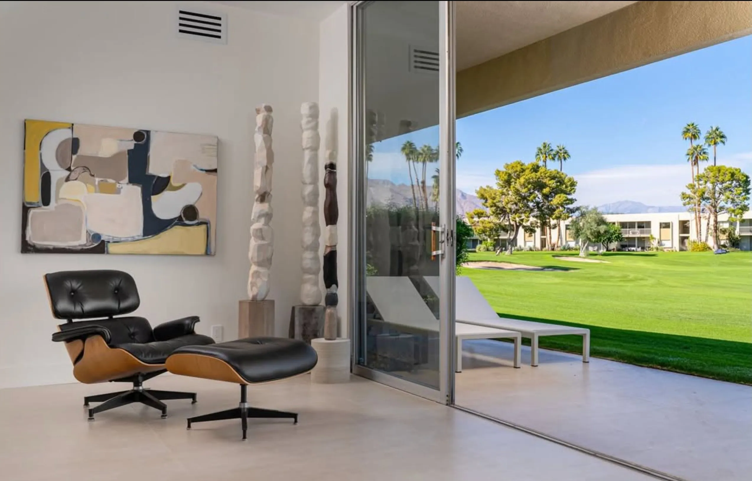 Eames lounge chair, carved totems, and a Lynda Keeler painting overlooking the fairway, Seven Lakes