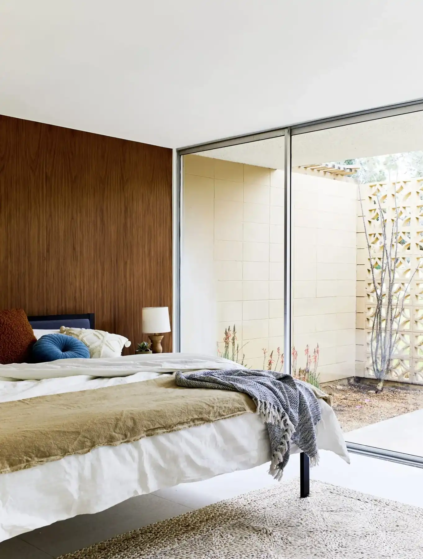 Walnut-paneled bedroom opening to a breeze block courtyard, Sandpiper condo, Palm Desert