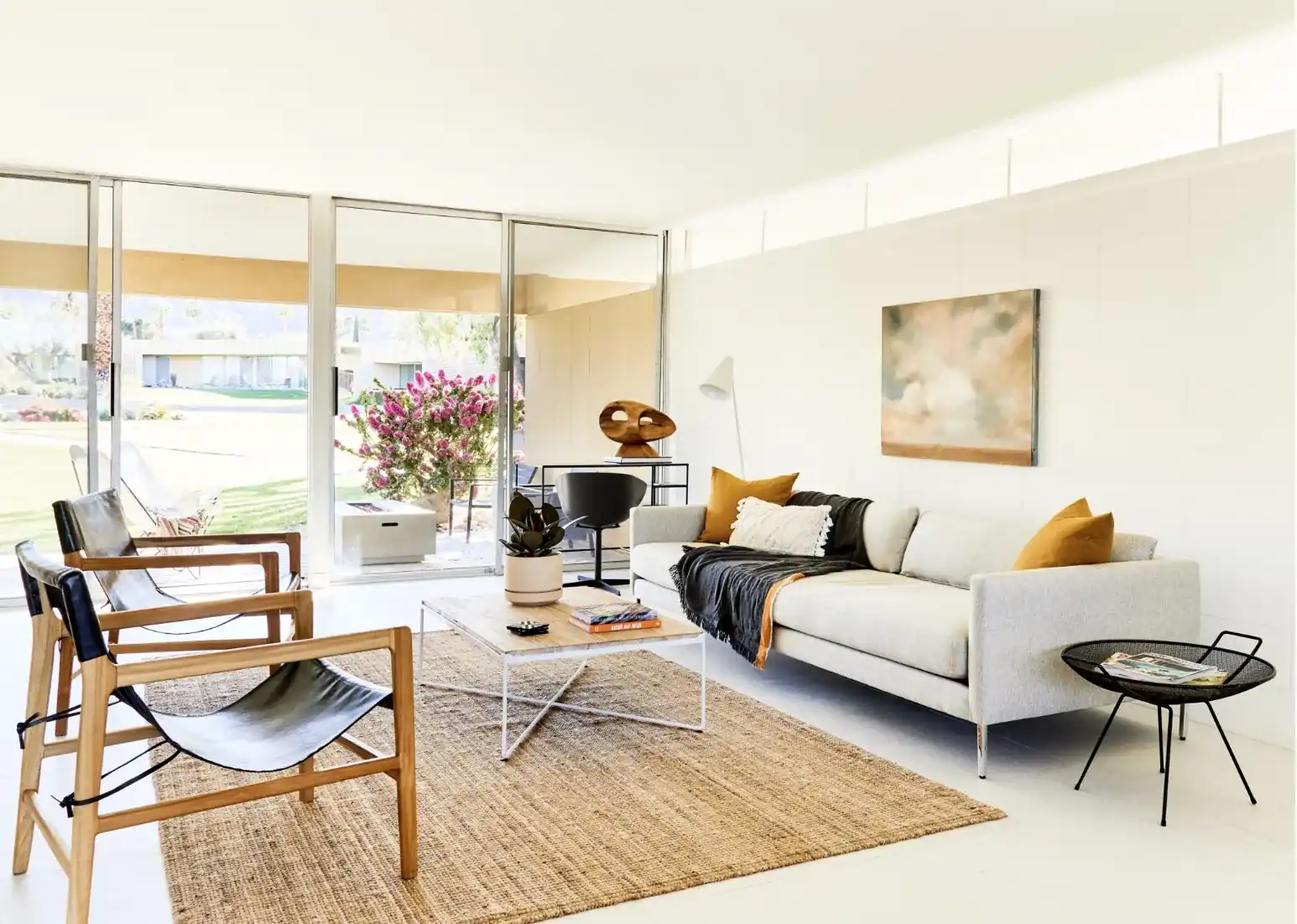 Living room with sling chairs and a sky painting by Christa Martin, Sandpiper condo, Palm Desert