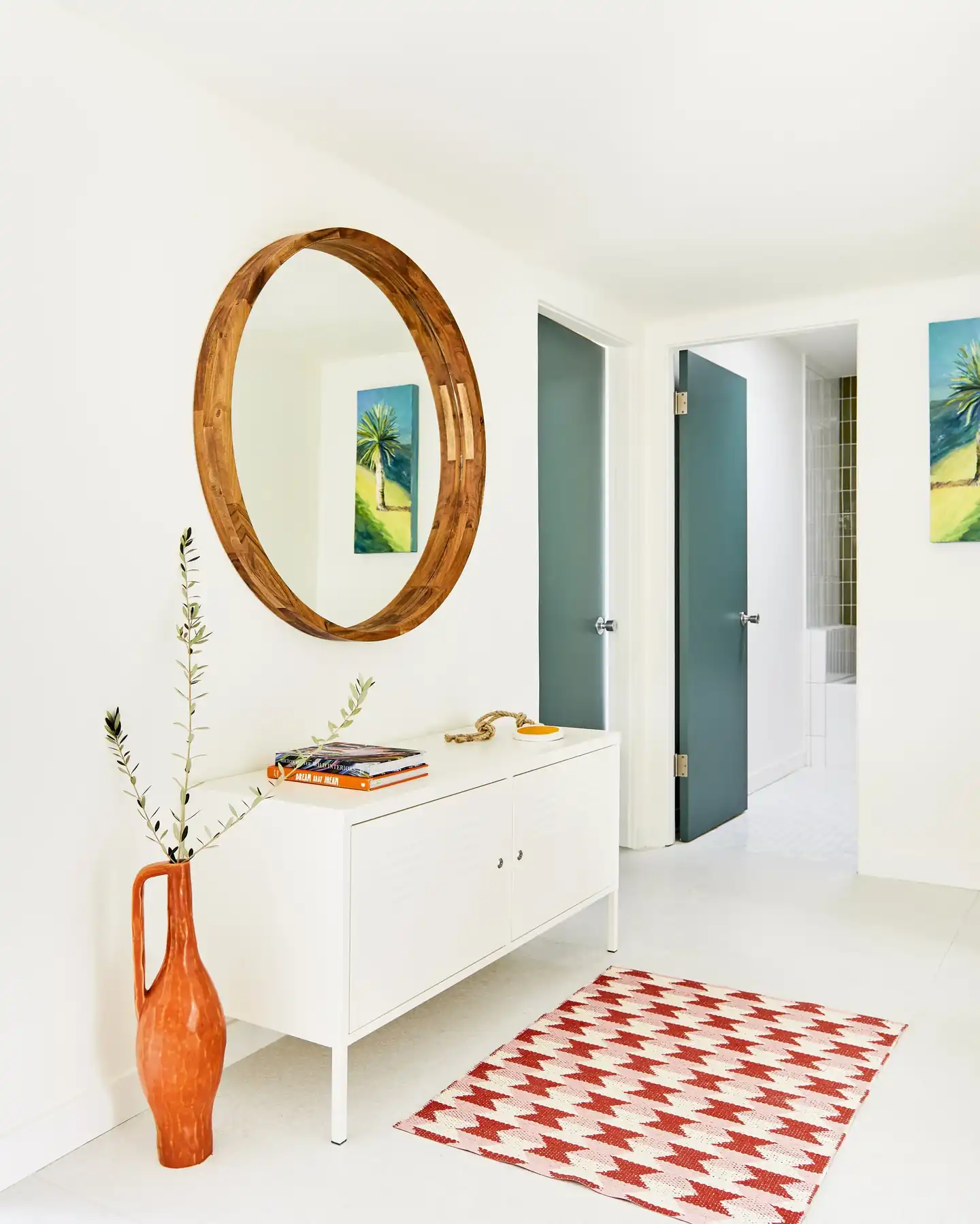 Entry hall with round wood mirror and teal doors, Sandpiper condo, Palm Desert