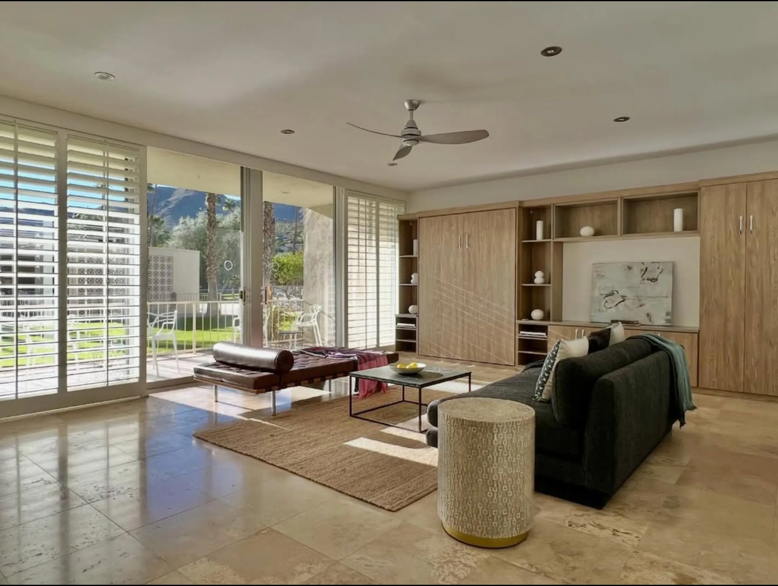Staged living room with travertine floors and leather daybed, Seven Lakes